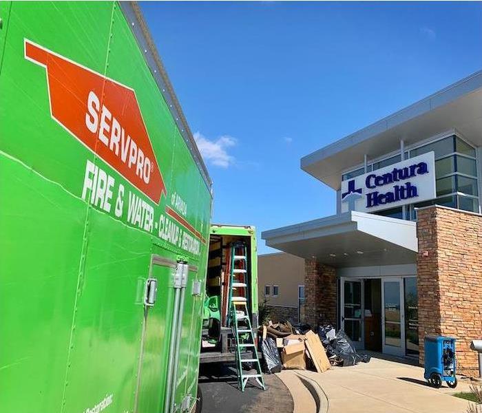 SERVPRO vehicles in front of commercial building. 