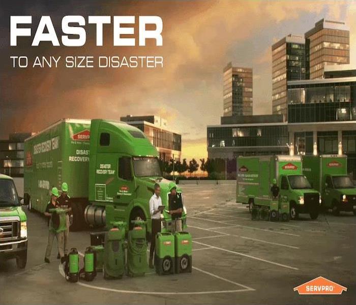 SERVPRO equipment and vehicles in front of an orange sky 